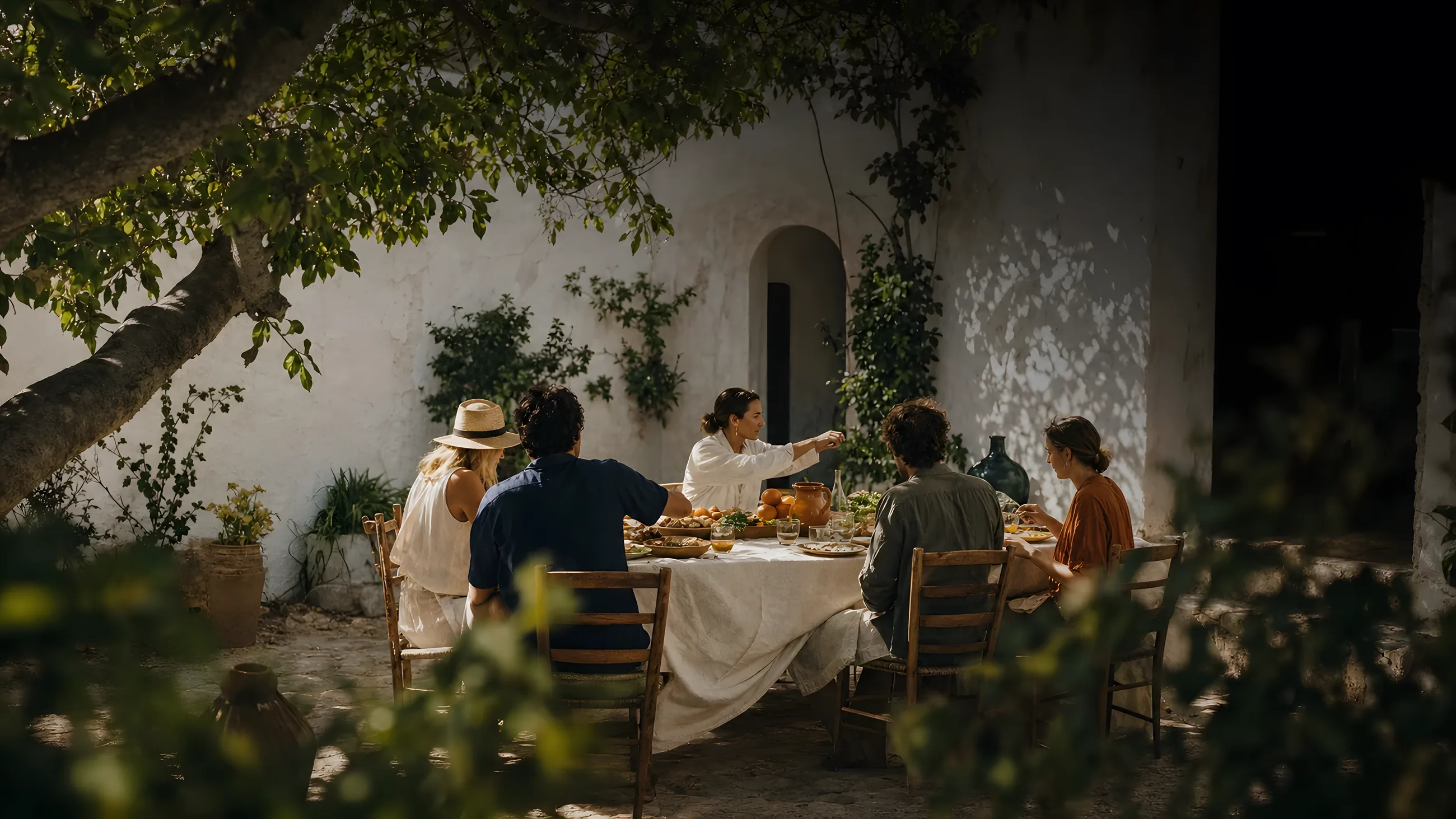A small group sharing lunch in a whitewashed Algarve courtyard
